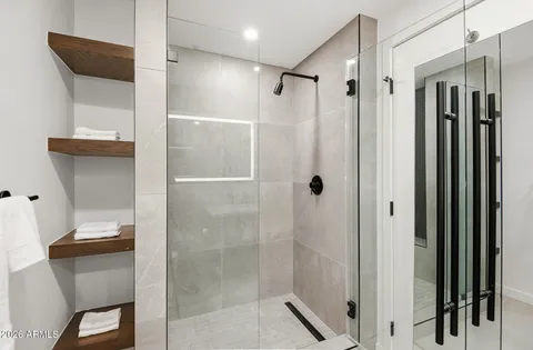 a bathroom with a shower and a sink