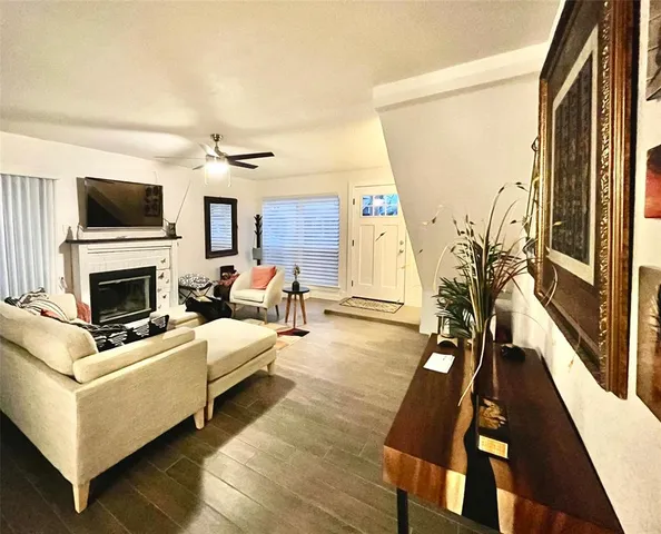 a living room with furniture fireplace and a flat screen tv