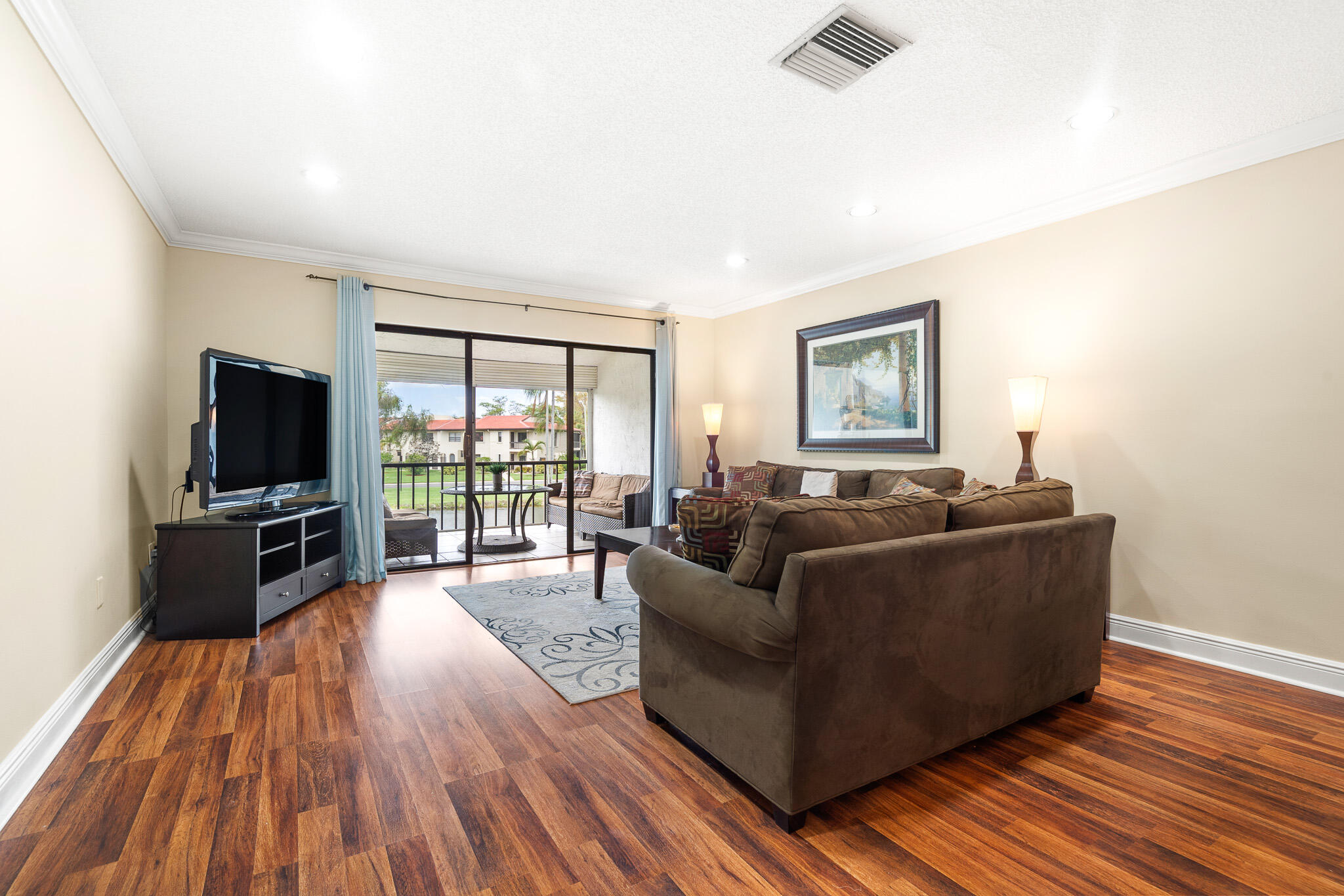 21218 Lago Circle, Unit H Boca Raton, FL 33433 - Photo 19 of 43 a living room with furniture and a flat screen tv