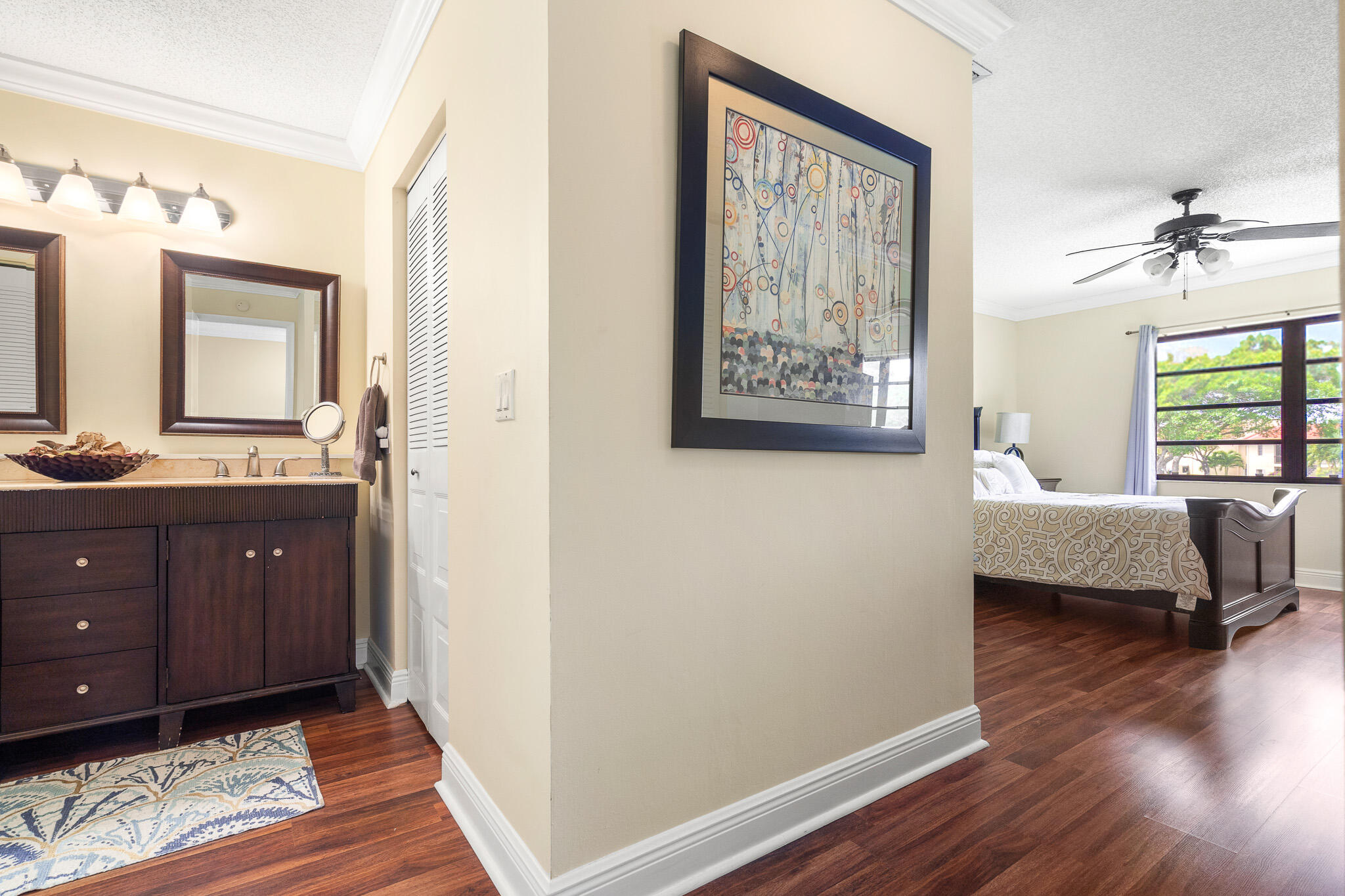 21218 Lago Circle, Unit H Boca Raton, FL 33433 - Photo 24 of 43 a bedroom with a bed and wooden floor