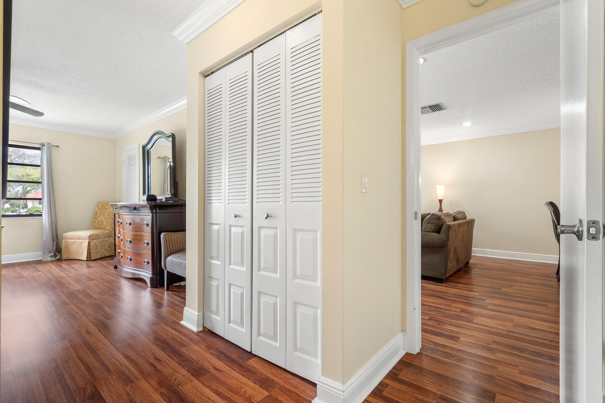21218 Lago Circle, Unit H Boca Raton, FL 33433 - Photo 27 of 43 a view of a hallway with wooden floor and furniture