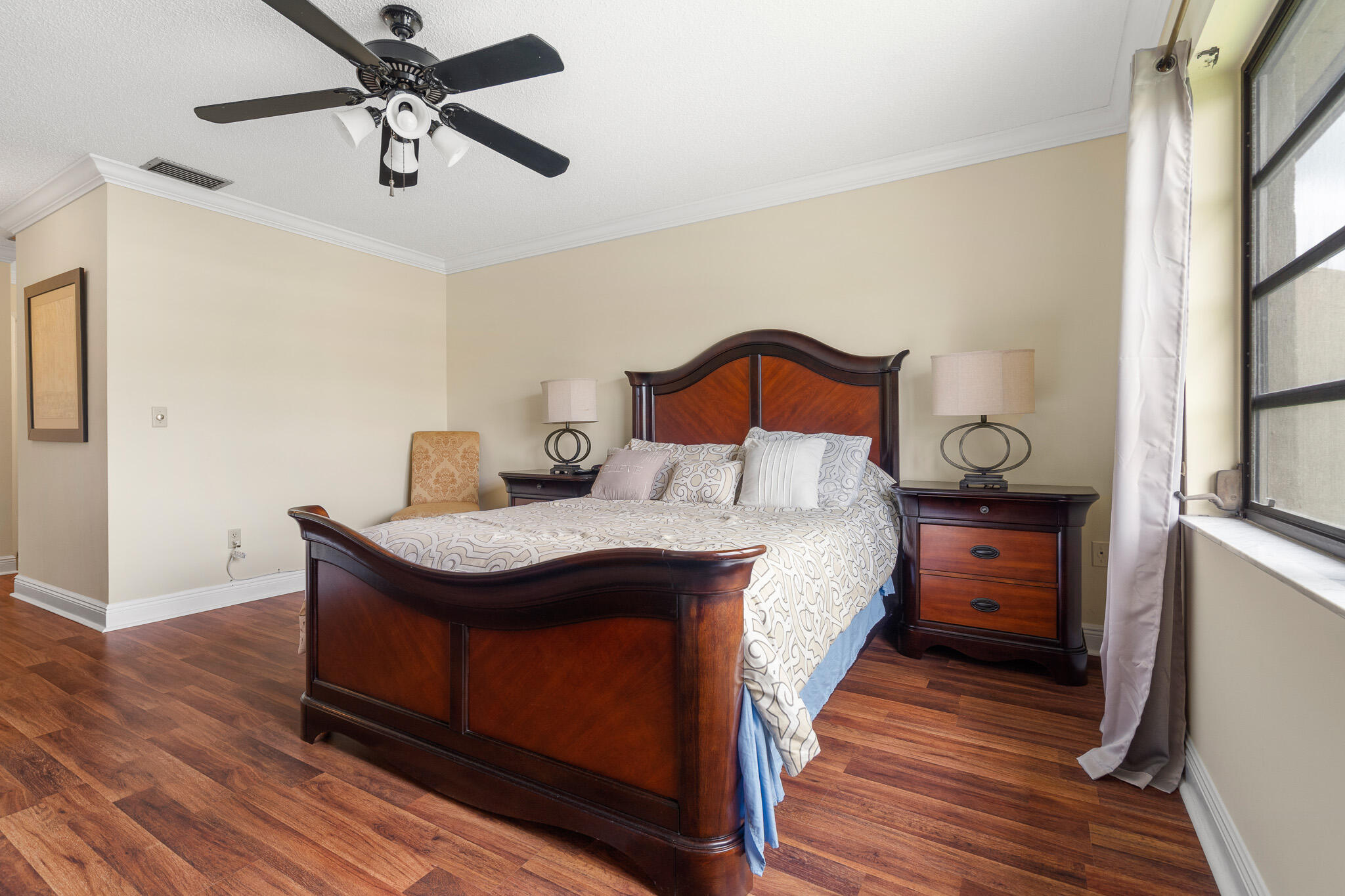 21218 Lago Circle, Unit H Boca Raton, FL 33433 - Photo 29 of 43 a bedroom with a bed and wooden floor