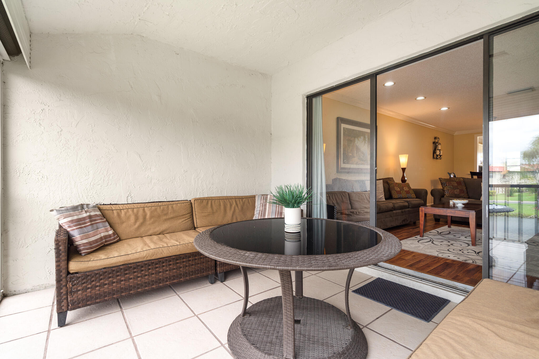 21218 Lago Circle, Unit H Boca Raton, FL 33433 - Photo 36 of 43 a living room with furniture and a potted plant