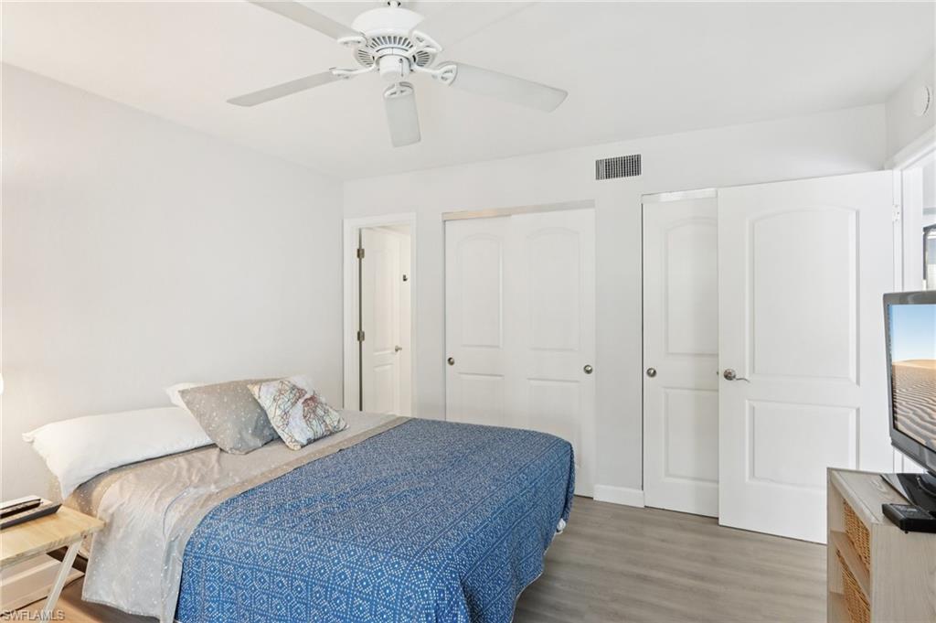 2185 San Marco Road, Unit 3103 Marco Island, FL 34145 - Photo 13 of 22 a bedroom with a bed and a chandelier