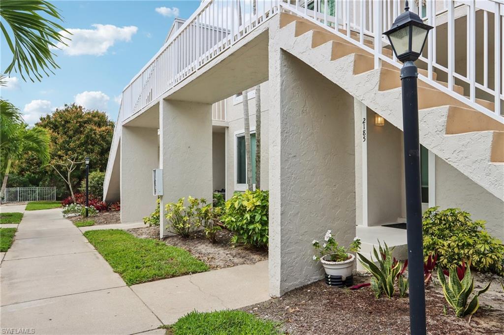 2185 San Marco Road, Unit 3103 Marco Island, FL 34145 - Photo 2 of 22 a view of a house with a yard and plants