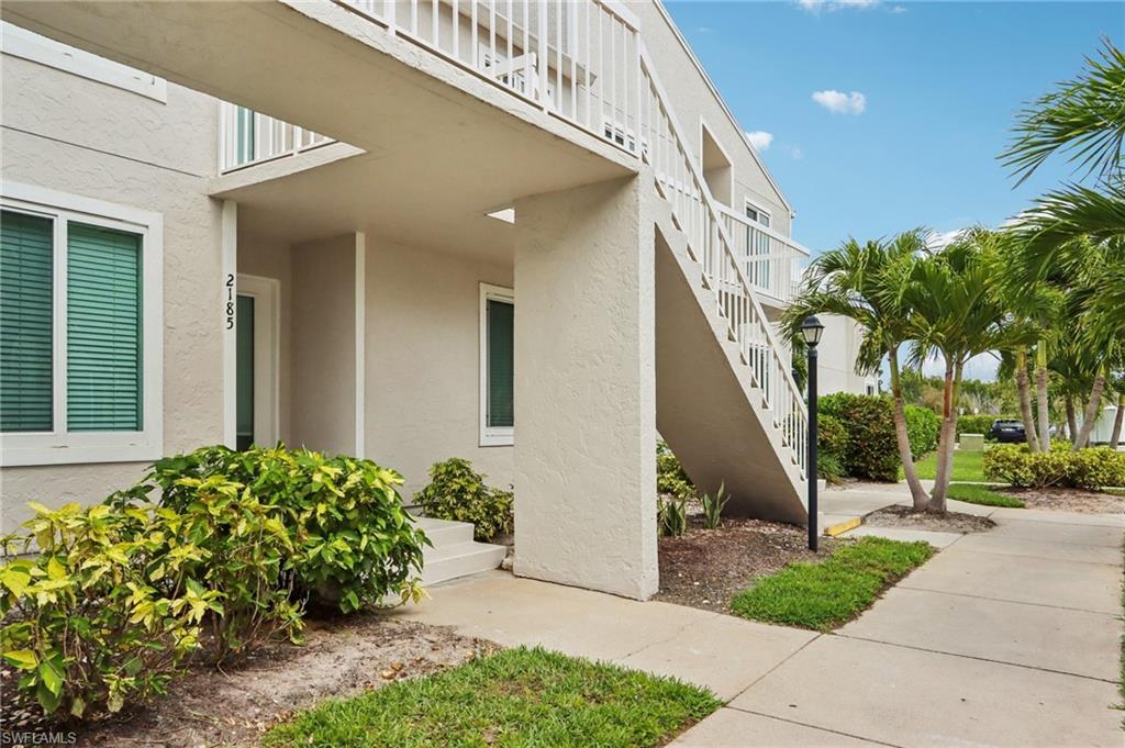 2185 San Marco Road, Unit 3103 Marco Island, FL 34145 - Photo 3 of 22 a front view of a house with a yard