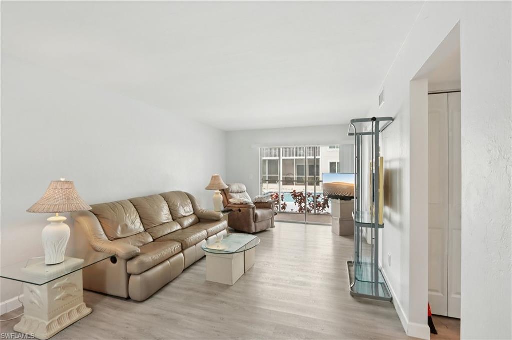 2185 San Marco Road, Unit 3103 Marco Island, FL 34145 - Photo 5 of 22 a living room with furniture and a fireplace