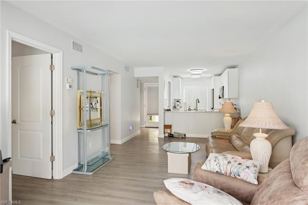 2185 San Marco Road, Unit 3103 Marco Island, FL 34145 - Photo 6 of 22 a living room with furniture and wooden floor