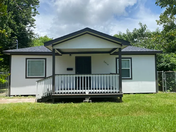 a view of a house with a yard and deck