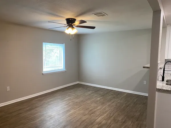 a kitchen with kitchen island granite countertop stainless steel appliances stove microwave and refrigerator