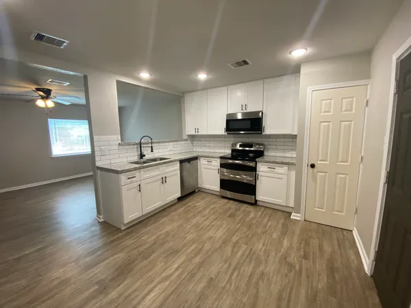a kitchen with a sink stainless steel appliances and cabinets