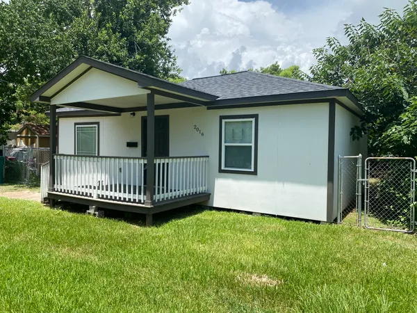a view of a house with a yard and deck