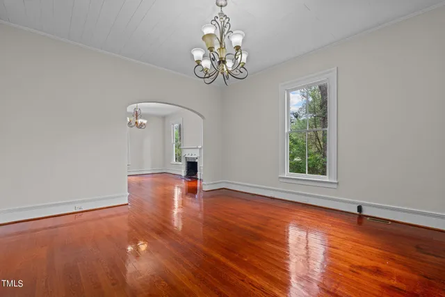 a view of a livingroom with a fireplace and window