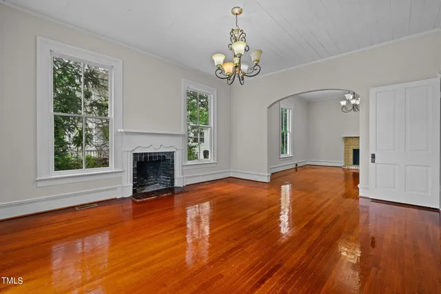 wooden floor in an empty room with a window