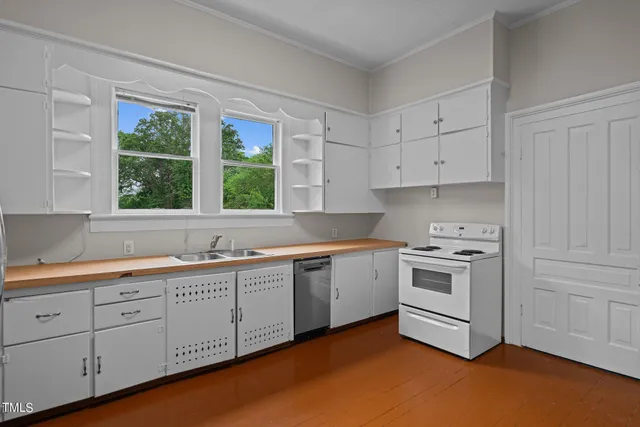 a kitchen with stainless steel appliances a sink and a window