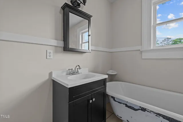 a bathroom with a granite countertop sink a toilet and a mirror