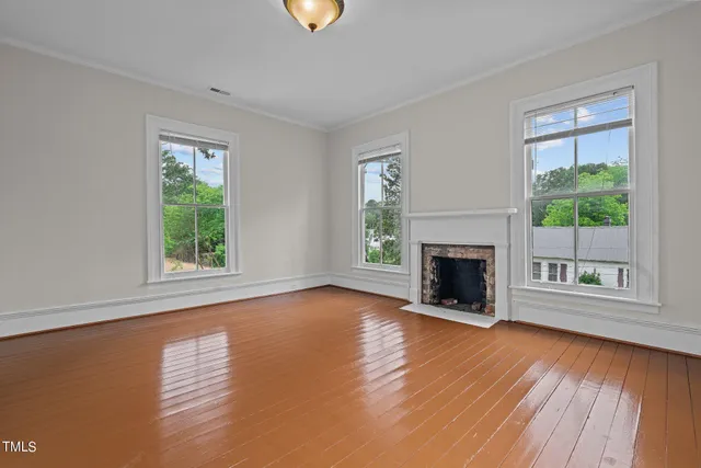 a view of an entryway wooden floor and chandelier