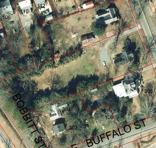 a picture of a yard with plants and lake view