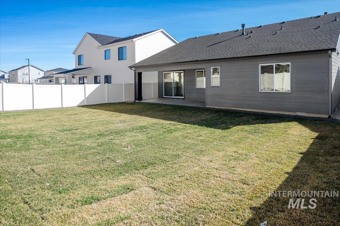 1689 West Paloma Rdg Street Kuna, ID 83634 - Photo 11 of 11 Back of house featuring a patio, a fenced backyard, and roof with shingles