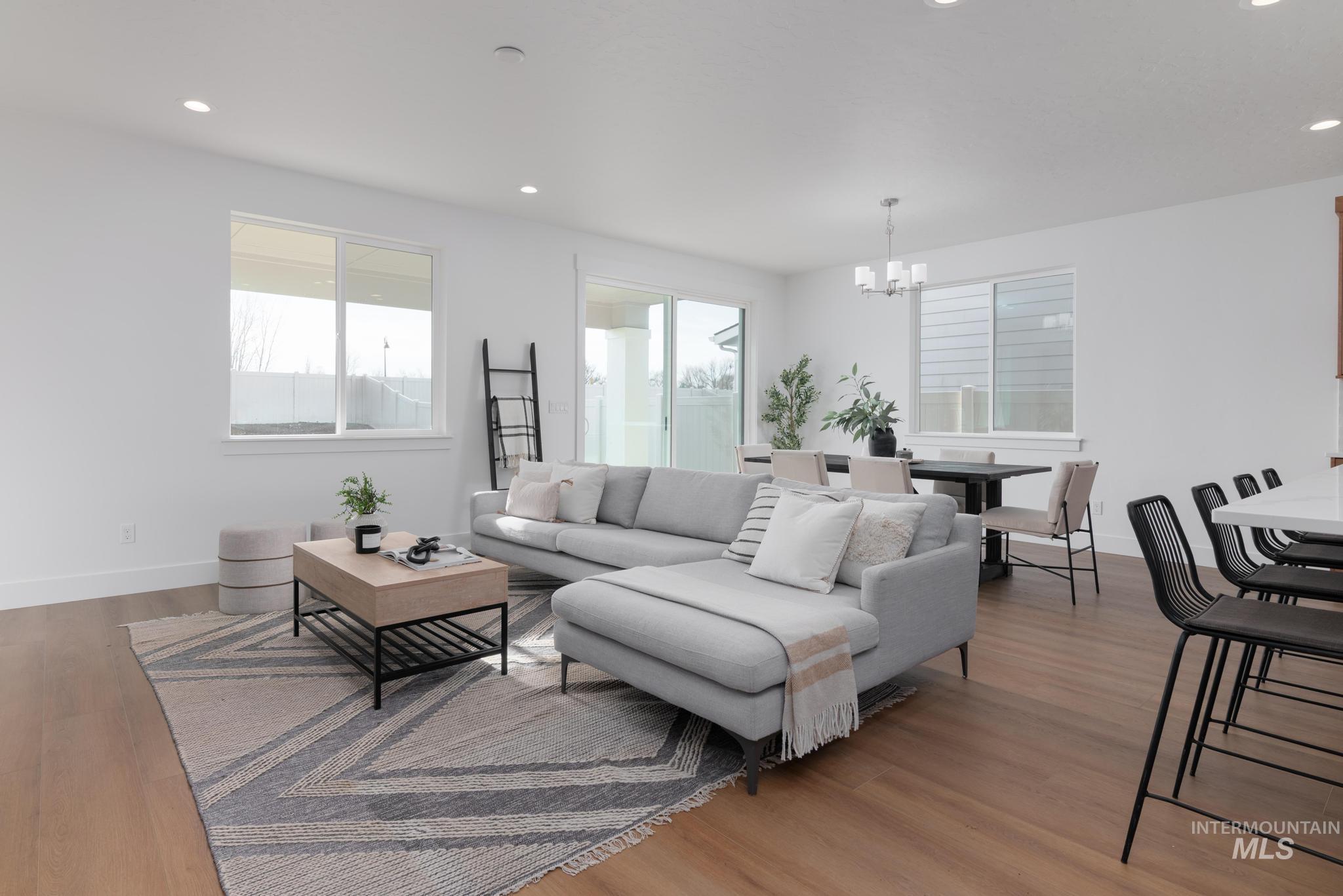 1689 West Paloma Rdg Street Kuna, ID 83634 - Photo 3 of 11 Living area featuring light wood-style floors and hanging lights