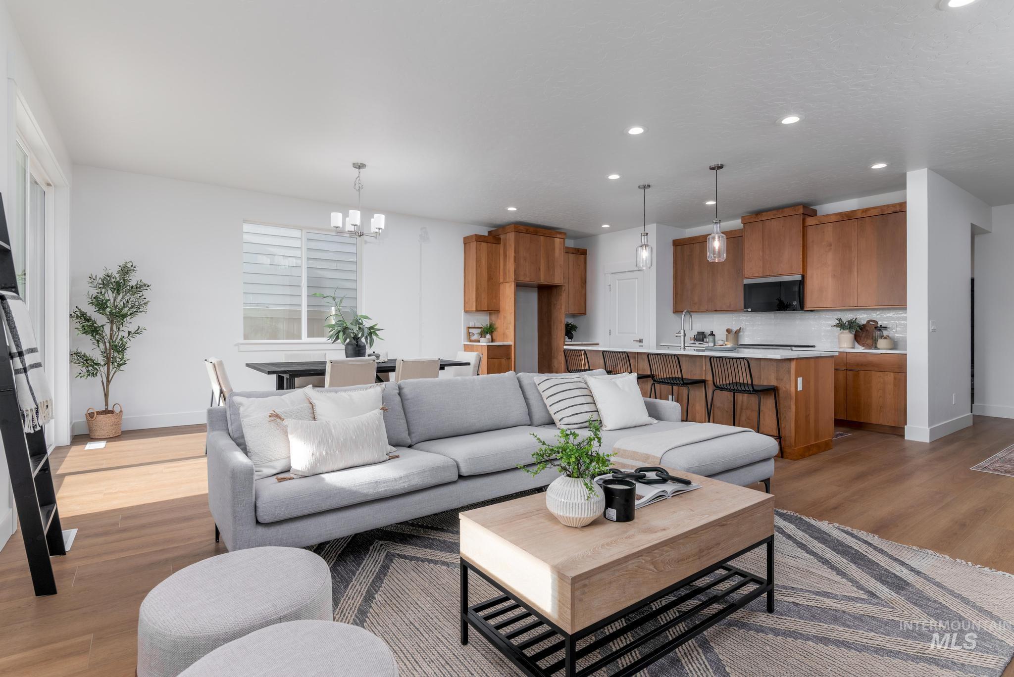 1689 West Paloma Rdg Street Kuna, ID 83634 - Photo 4 of 11 Living area featuring light wood-type flooring and hanging lights