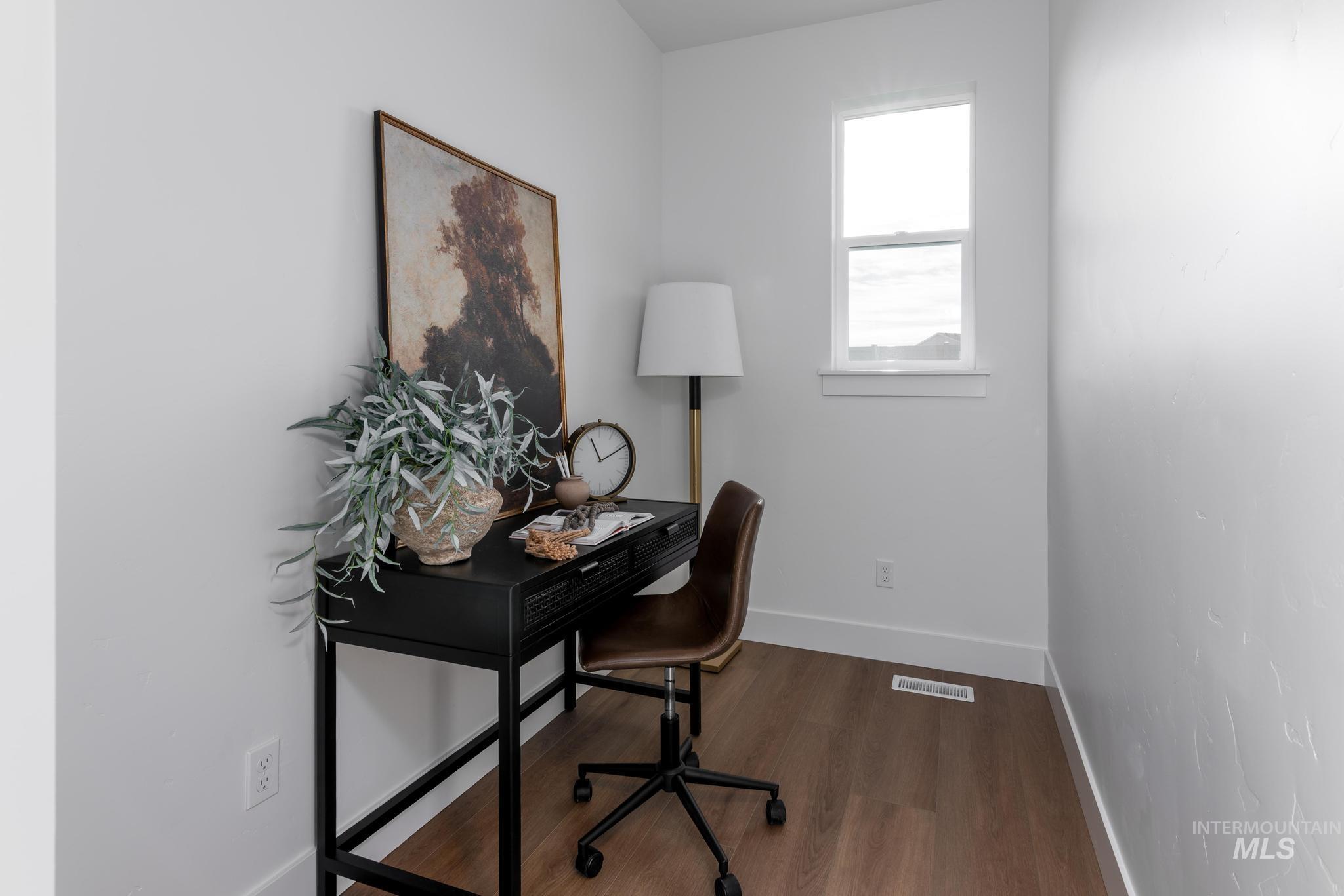 1689 West Paloma Rdg Street Kuna, ID 83634 - Photo 9 of 11 Home office with baseboards and dark wood-style flooring