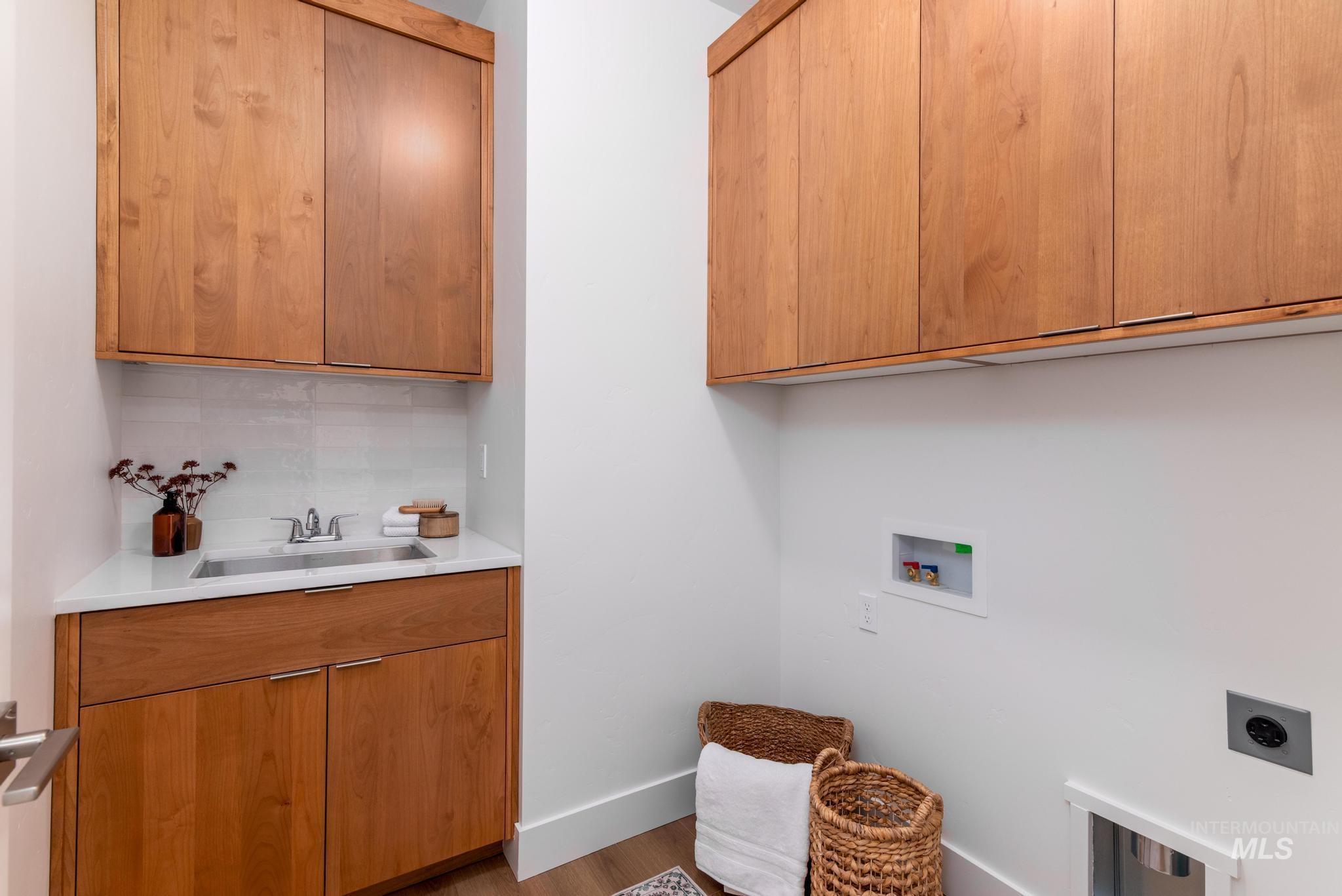 1689 West Paloma Rdg Street Kuna, ID 83634 - Photo 10 of 11 Laundry room with cabinet space, hookup for a washing machine, wood finished floors, and electric dryer hookup