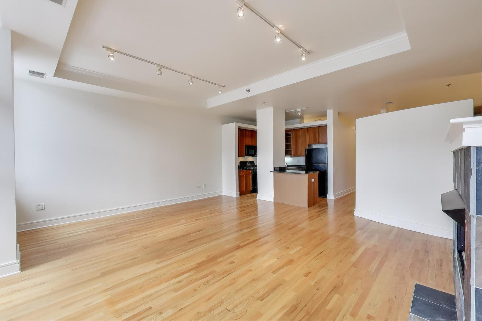 212 West Washington Street, Unit 1708 Chicago, IL 60606 - Photo 7 of 36 a view of an empty room with wooden floor