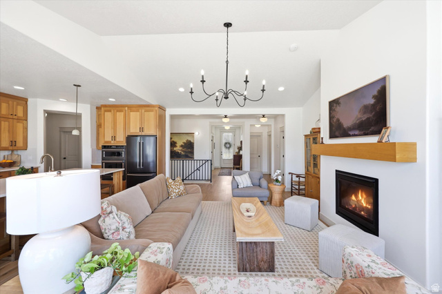 283 North 500 West Mapleton, UT 84664 - Photo 12 of 102 Living area featuring suspended lighting, a glass covered fireplace, and lofted ceiling