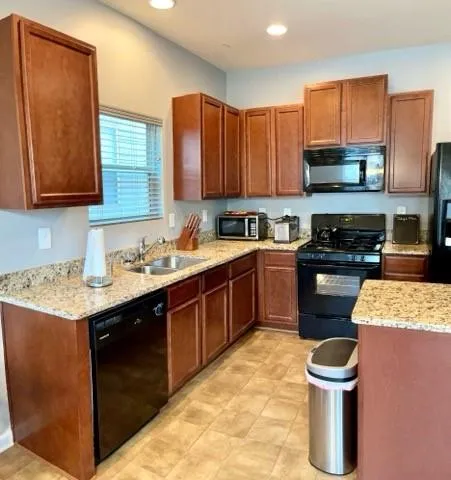 a kitchen with a sink stove top oven and microwave