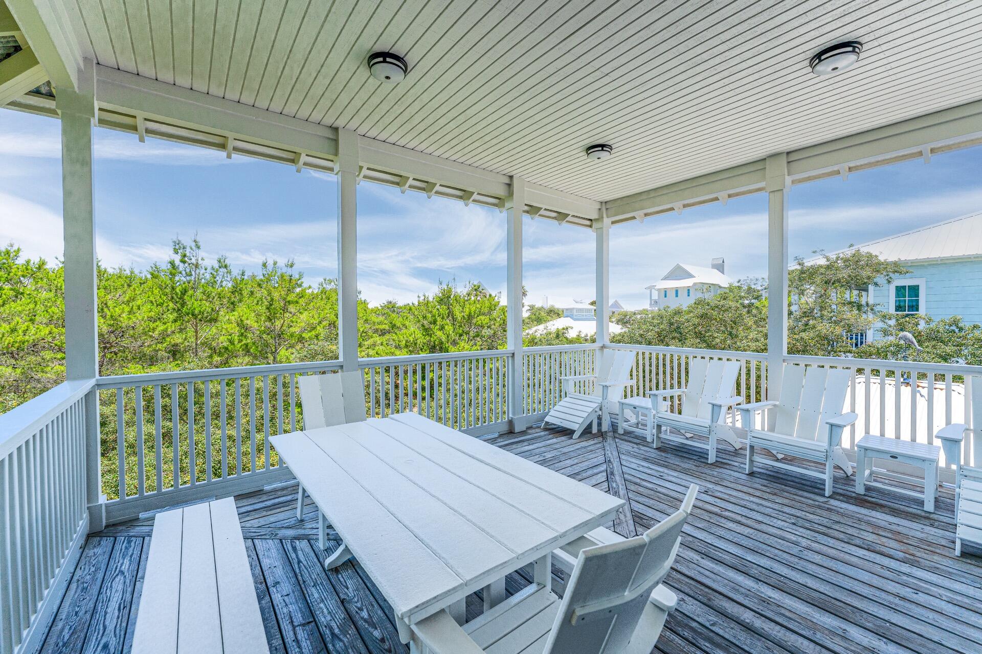 186 Old Beach Road Santa Rosa Beach, FL 32459 - Photo 17 of 21 a view of deck with table and chairs and wooden floor