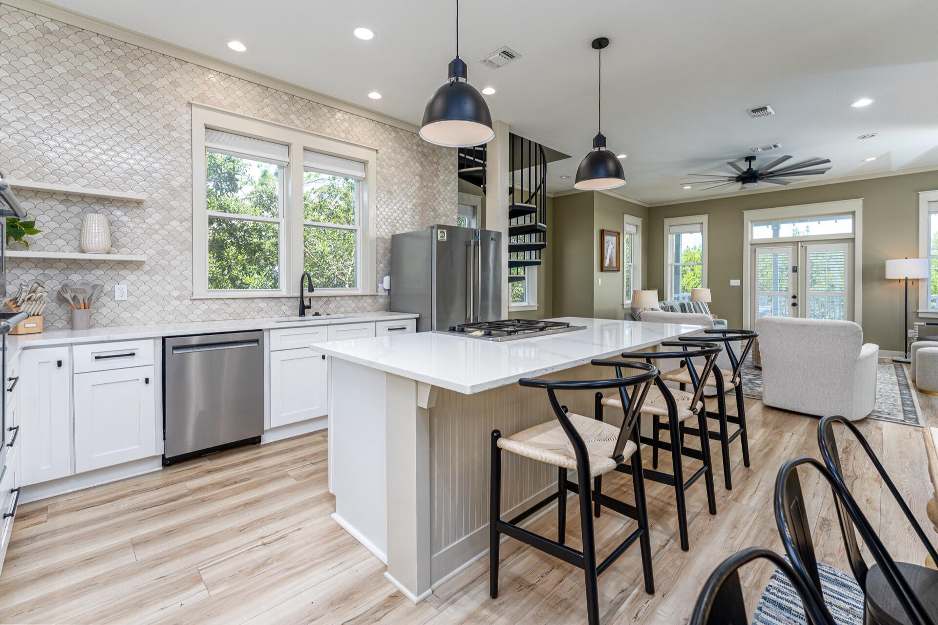 186 Old Beach Road Santa Rosa Beach, FL 32459 - Photo 3 of 21 a kitchen with a table chairs sink and cabinets