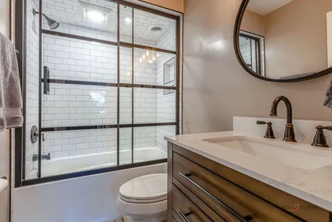 a bathroom with a sink a toilet and a mirror