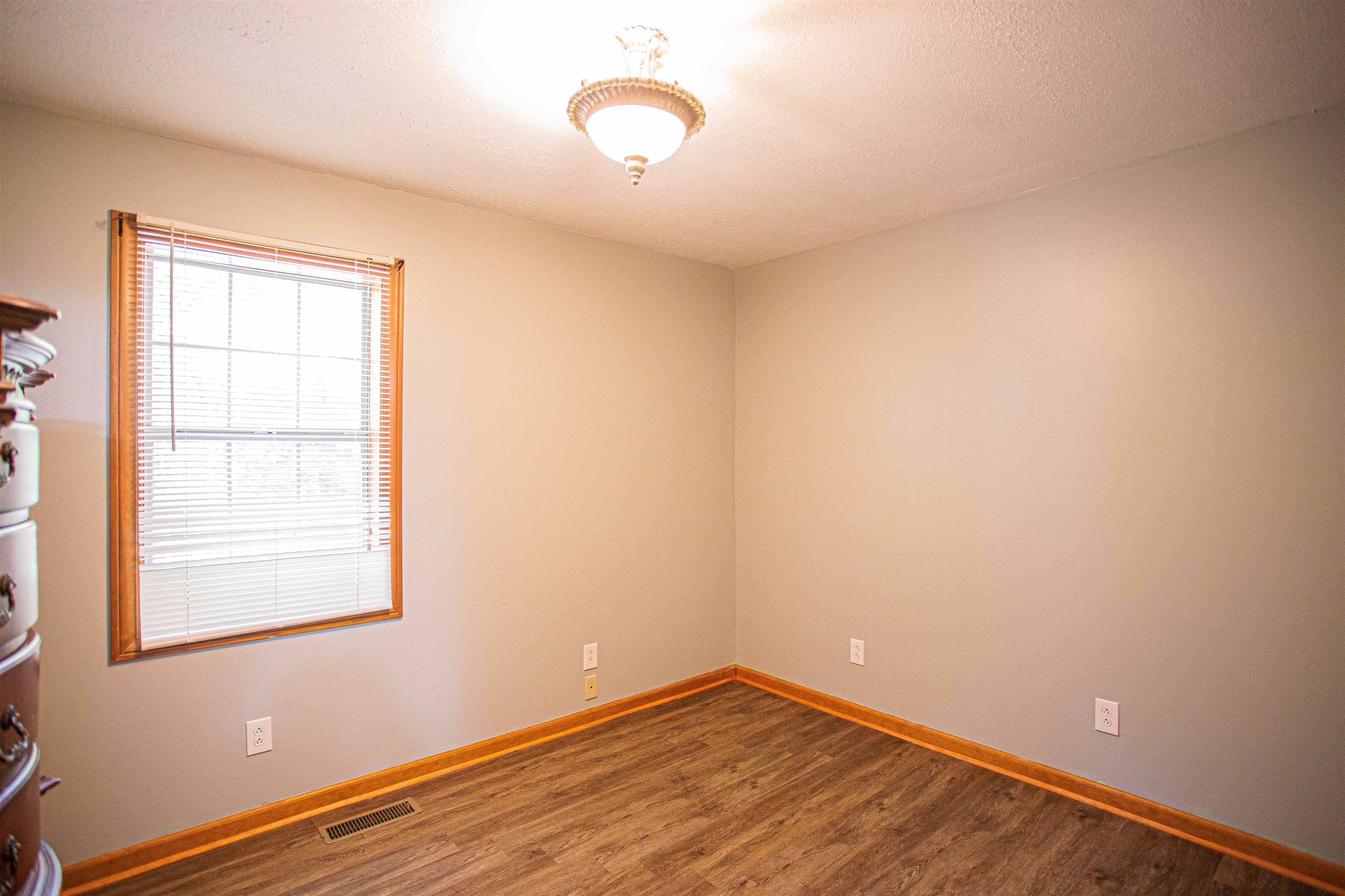 90 Aubrey Lane Ripley, TN 38063 - Photo 12 of 25 an empty room with wooden floor and windows