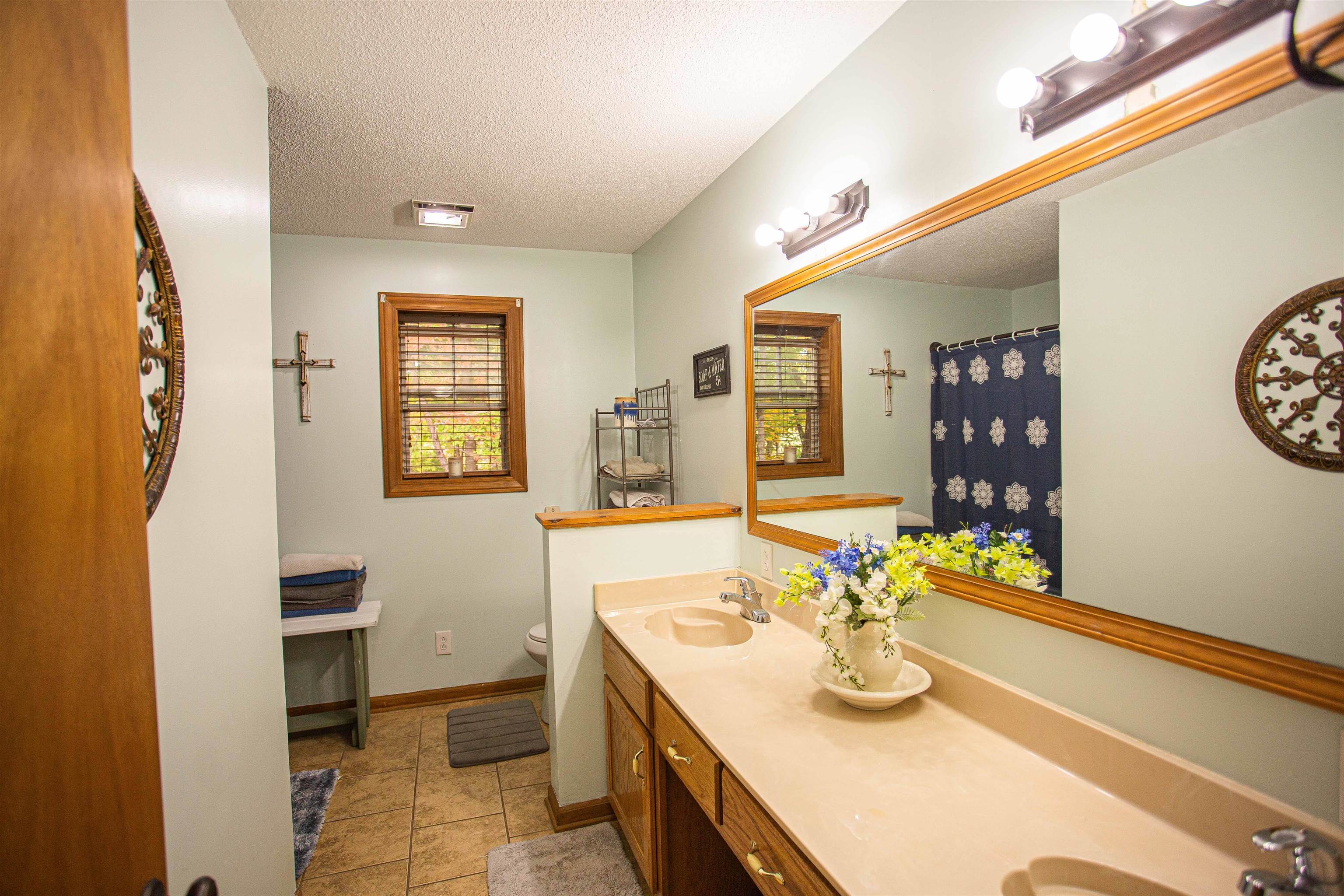 90 Aubrey Lane Ripley, TN 38063 - Photo 13 of 25 a bathroom with a sink a vanity and a mirror