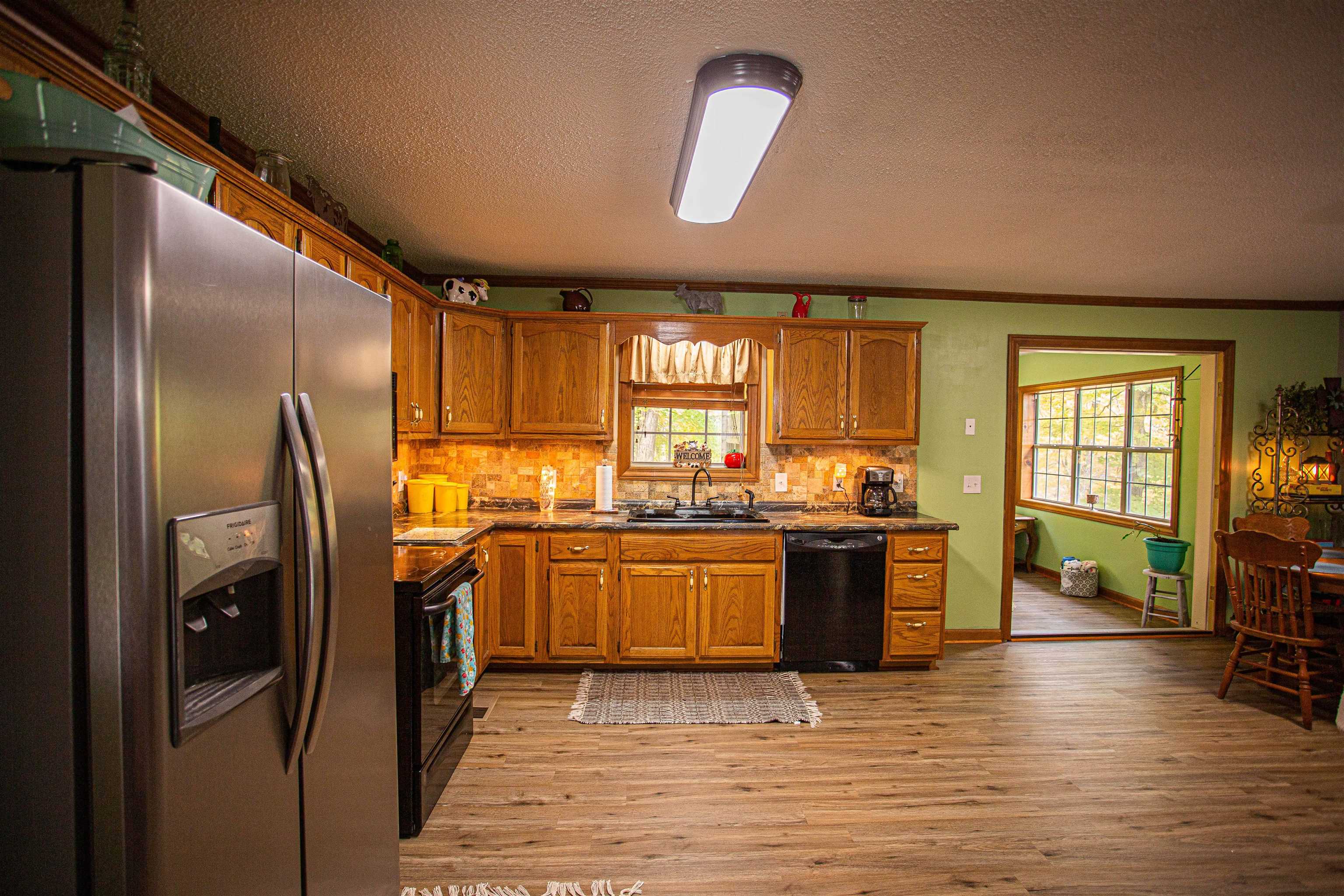 90 Aubrey Lane Ripley, TN 38063 - Photo 5 of 25 a kitchen with stainless steel appliances granite countertop a refrigerator a stove top oven a sink and dishwasher