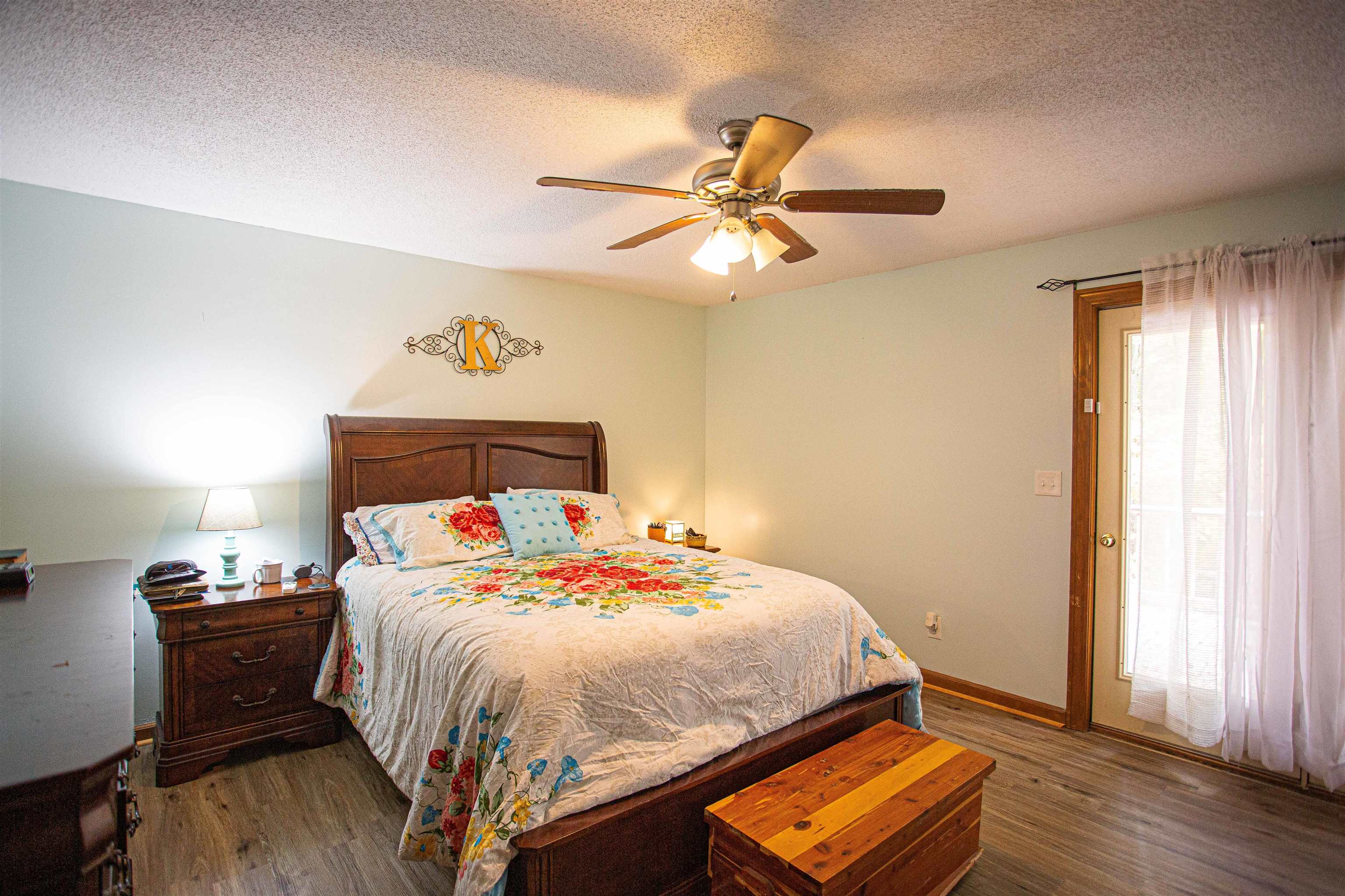 90 Aubrey Lane Ripley, TN 38063 - Photo 9 of 25 a bedroom with a bed and wooden floor
