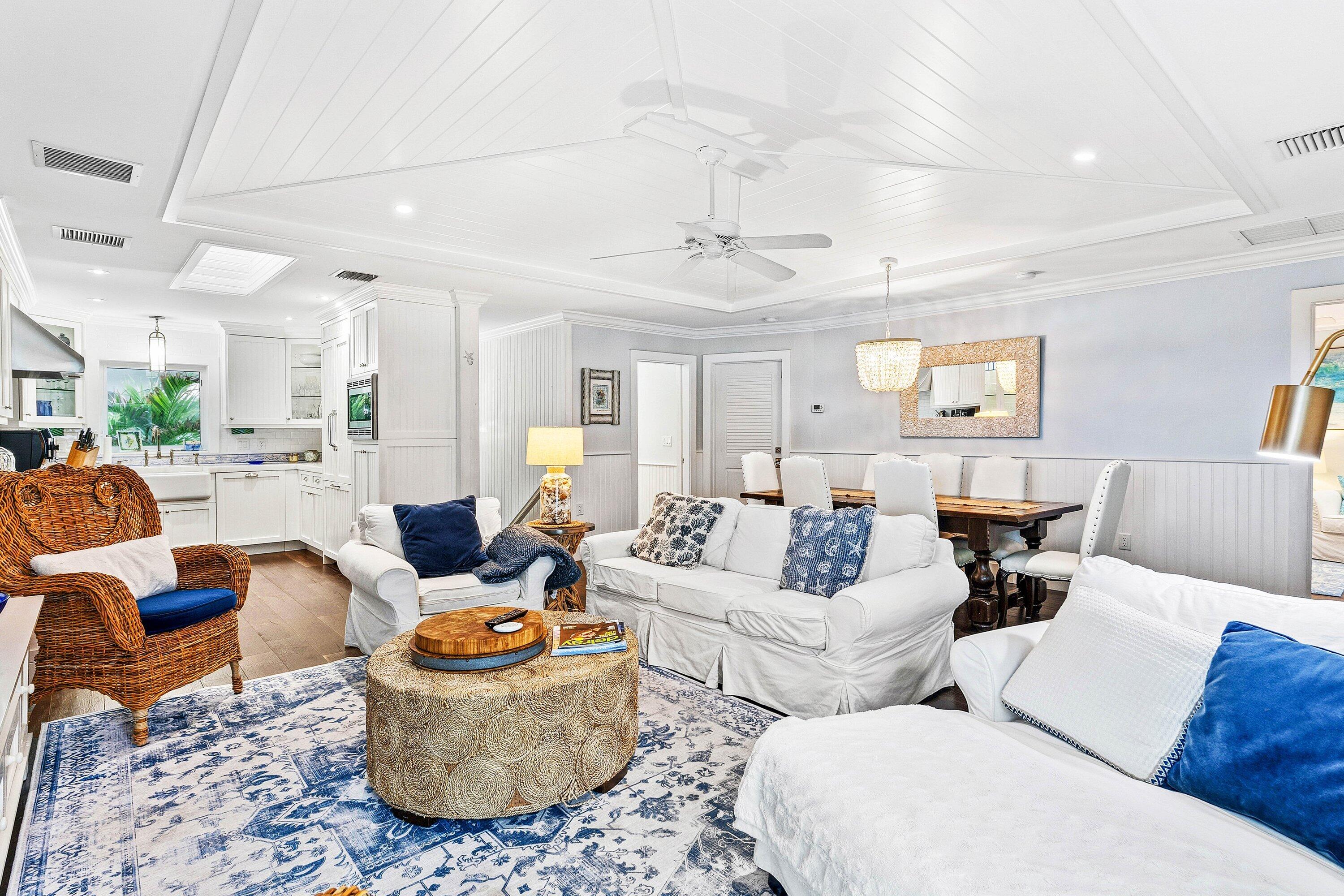 3421 South Ocean Boulevard, Unit 1 Highland Beach, FL 33487 - Photo 11 of 42 a living room with furniture and a chandelier