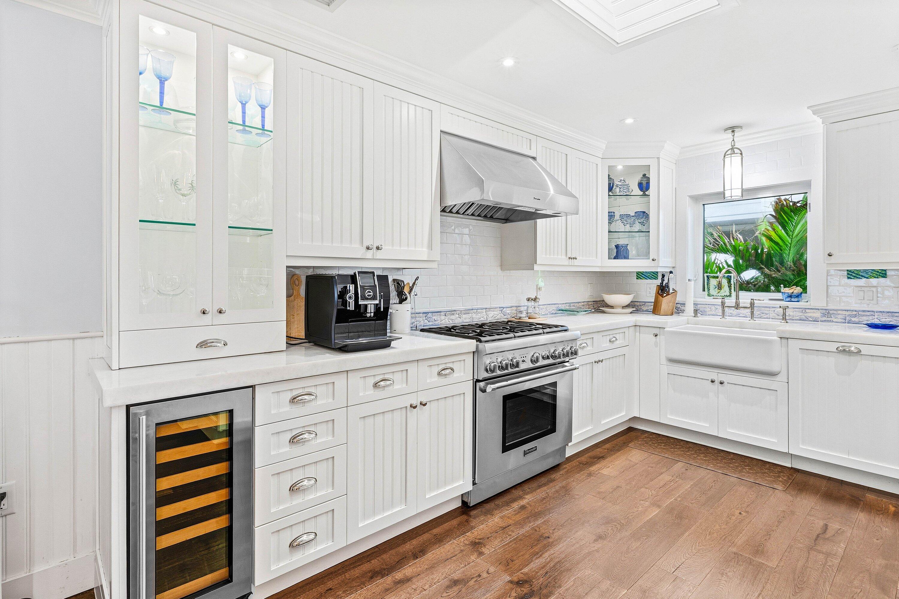 3421 South Ocean Boulevard, Unit 1 Highland Beach, FL 33487 - Photo 14 of 42 a kitchen with granite countertop white cabinets and white appliances