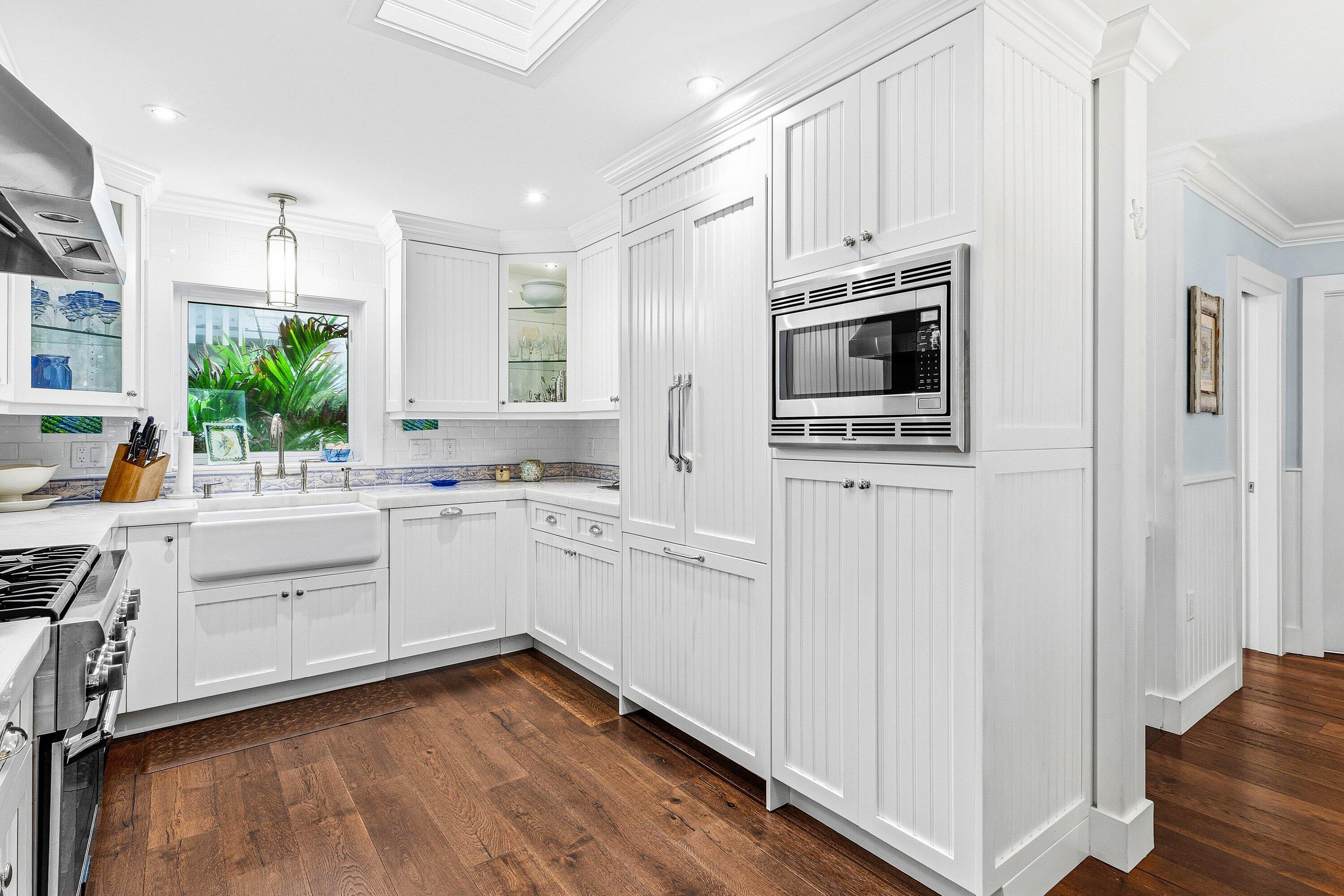 3421 South Ocean Boulevard, Unit 1 Highland Beach, FL 33487 - Photo 15 of 42 a kitchen with cabinets oven and a dishwasher