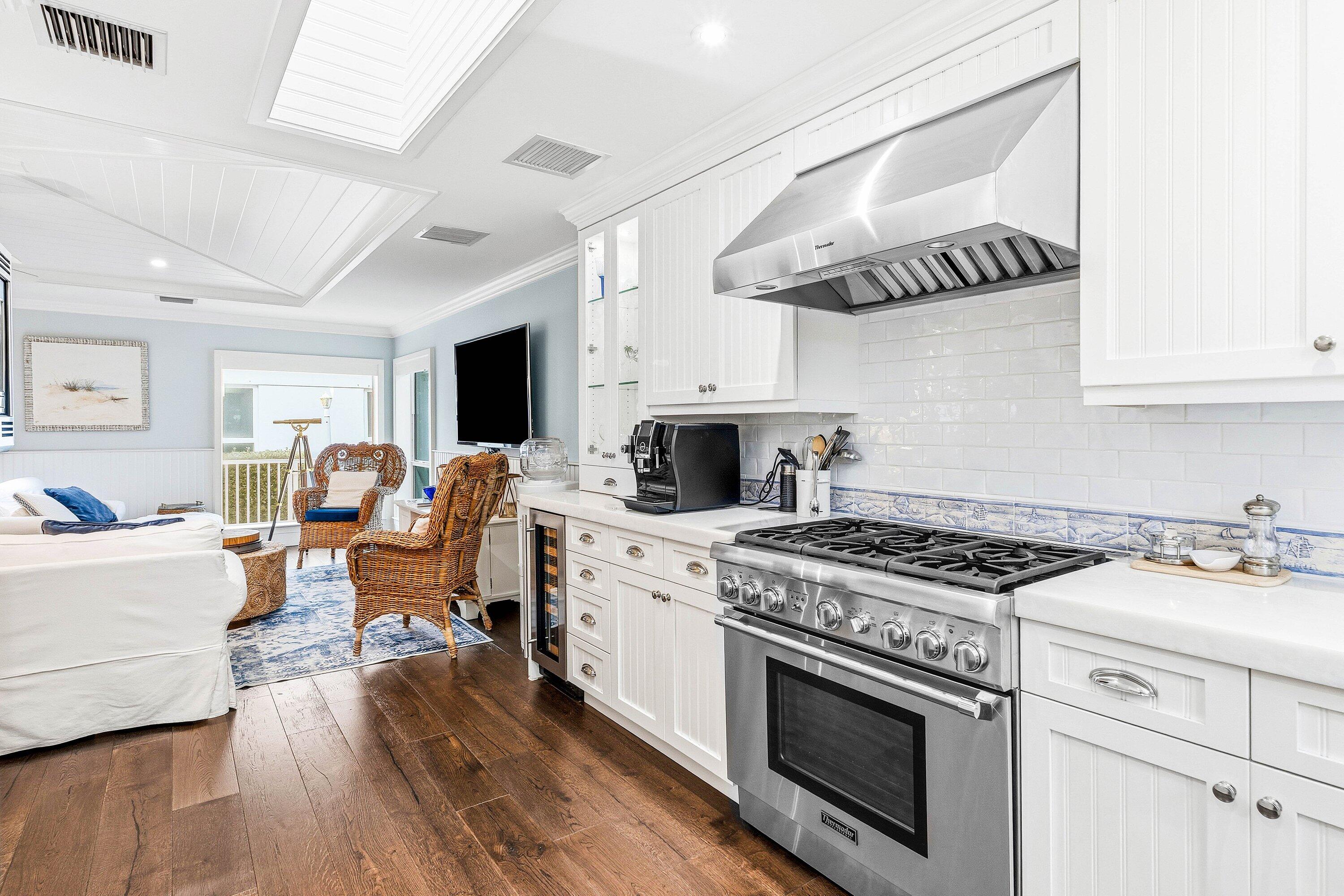 3421 South Ocean Boulevard, Unit 1 Highland Beach, FL 33487 - Photo 16 of 42 a open kitchen with stainless steel appliances granite countertop a stove and a wooden floors