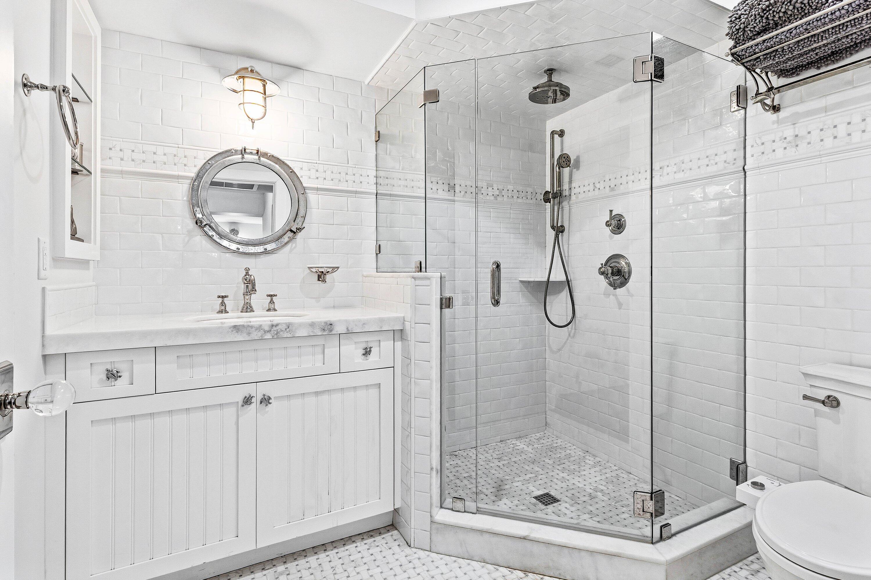 3421 South Ocean Boulevard, Unit 1 Highland Beach, FL 33487 - Photo 20 of 42 a bathroom with a shower sink mirror and toilet