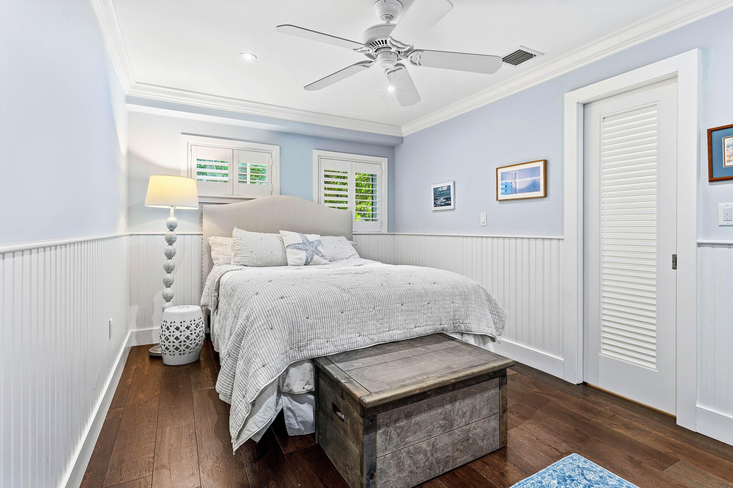 3421 South Ocean Boulevard, Unit 1 Highland Beach, FL 33487 - Photo 22 of 42 a bedroom with a bed and wooden floor