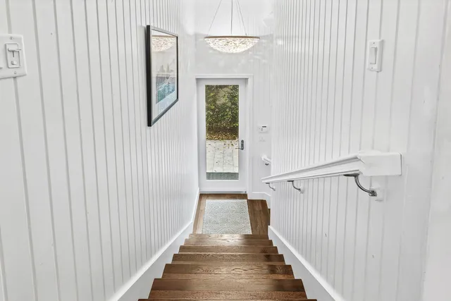 a bathroom with a granite countertop toilet sink and mirror
