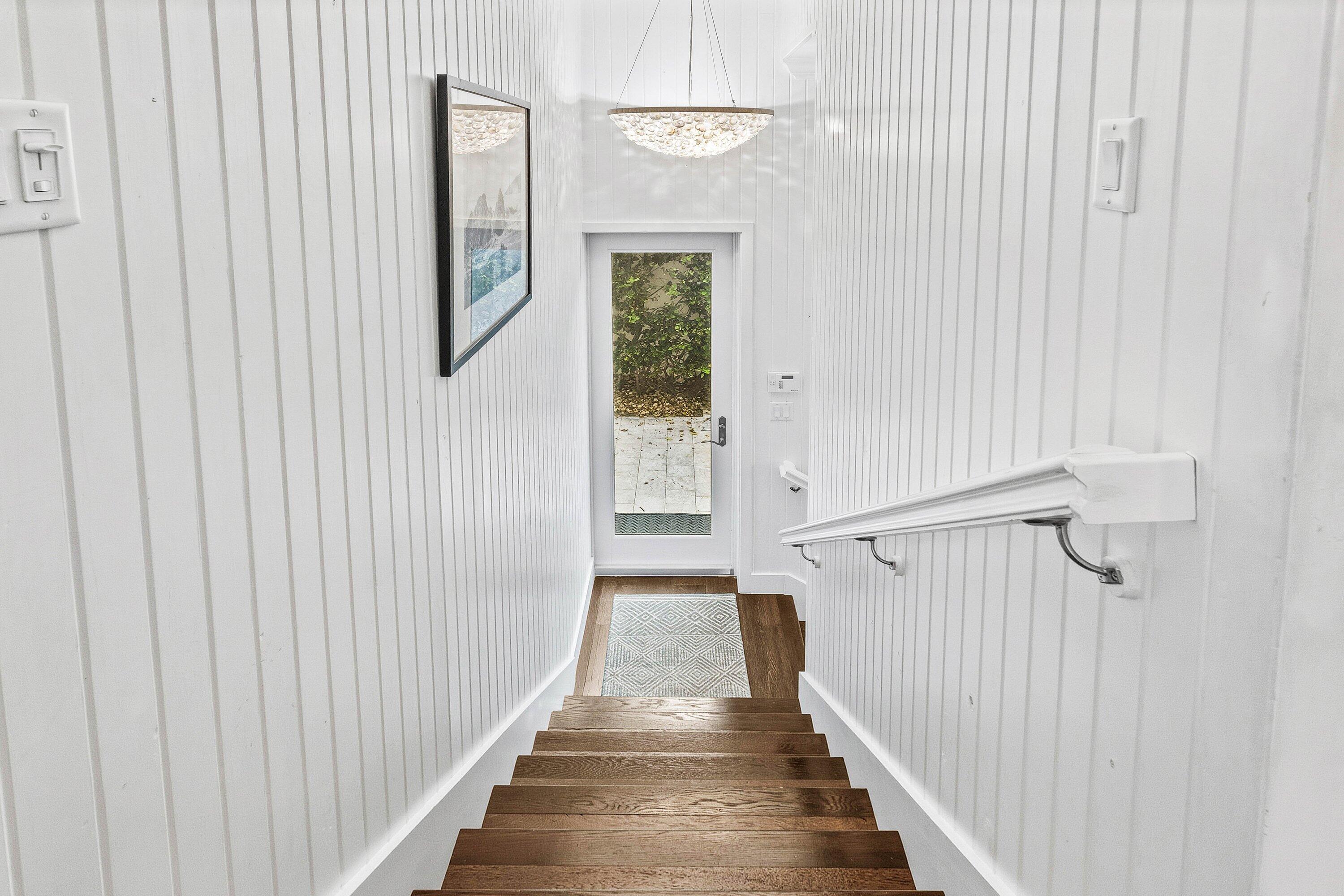 3421 South Ocean Boulevard, Unit 1 Highland Beach, FL 33487 - Photo 6 of 42 a view of a hallway with wooden floor and entryway