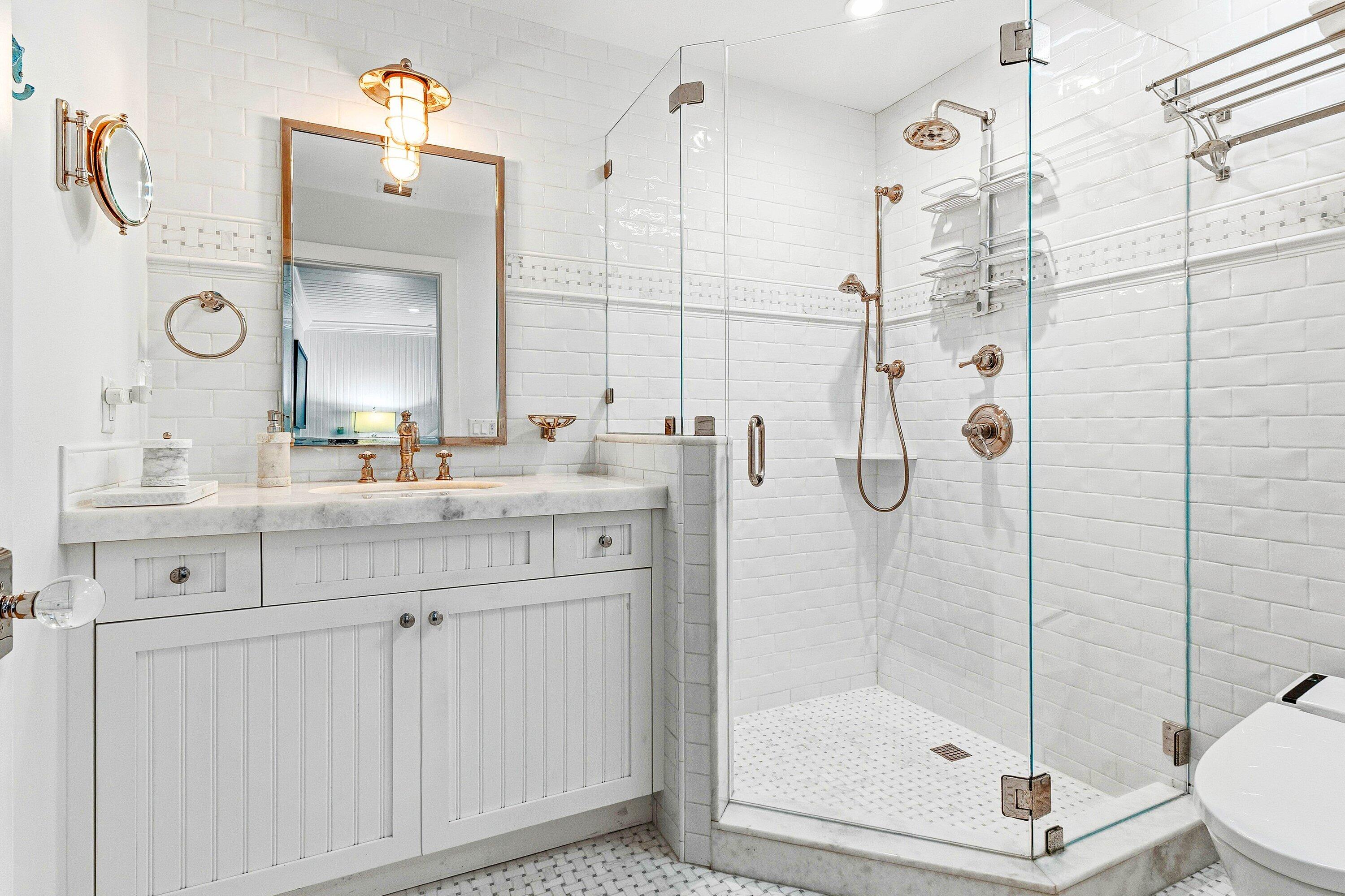 3421 South Ocean Boulevard, Unit 1 Highland Beach, FL 33487 - Photo 7 of 42 a bathroom with a shower sink mirror and toilet