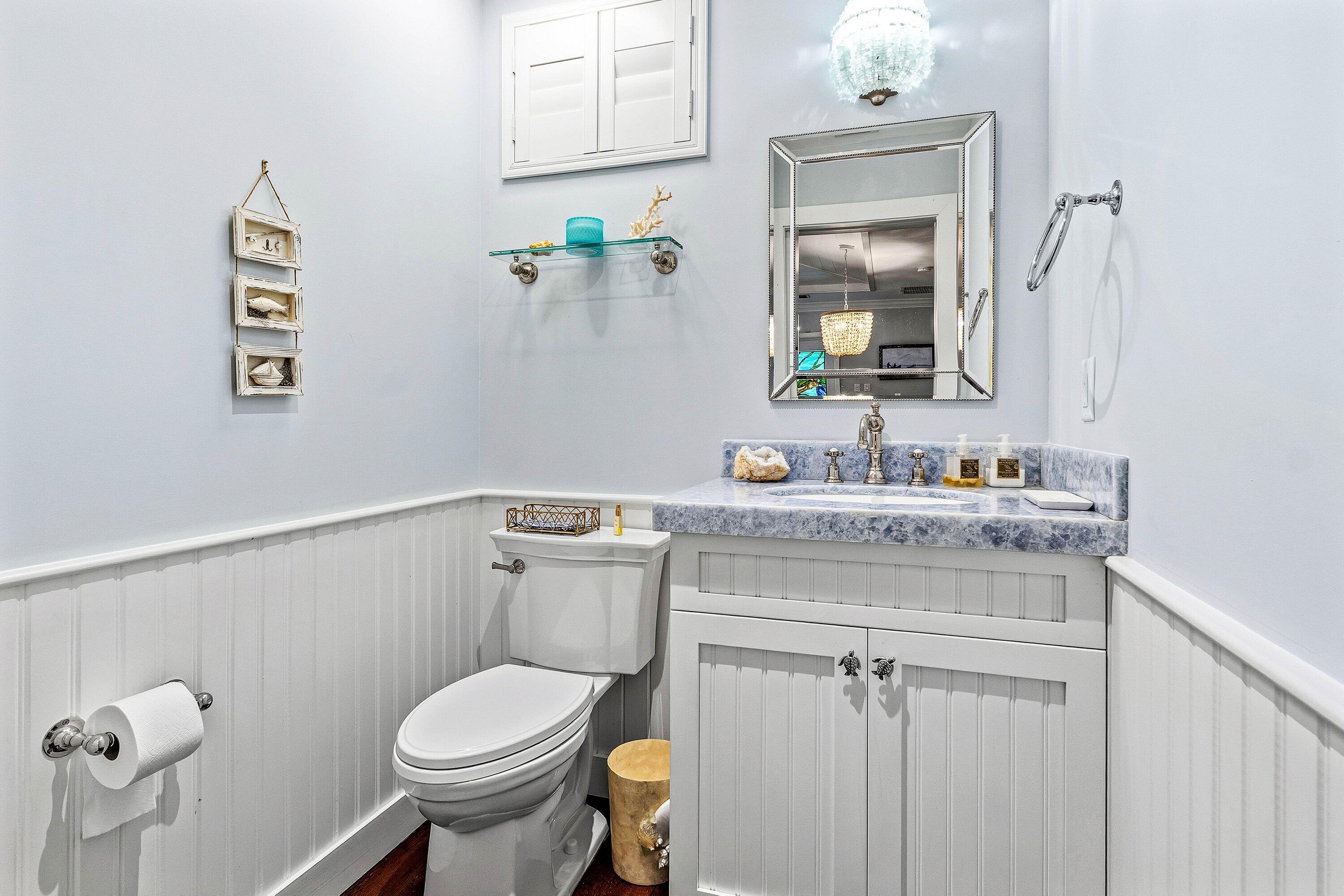 3421 South Ocean Boulevard, Unit 1 Highland Beach, FL 33487 - Photo 8 of 42 a bathroom with a granite countertop toilet sink and mirror