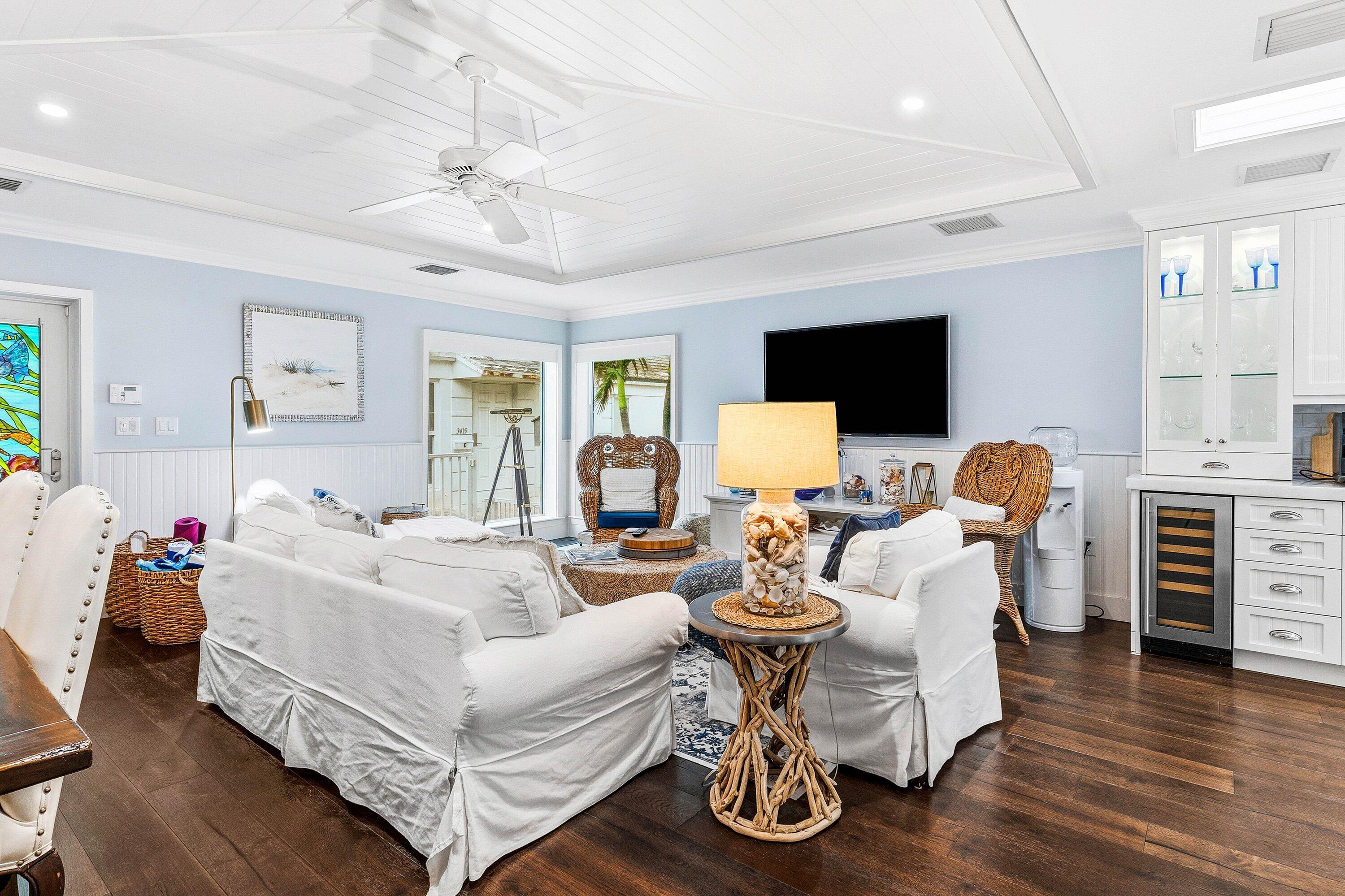 3421 South Ocean Boulevard, Unit 1 Highland Beach, FL 33487 - Photo 9 of 42 a living room with furniture flat screen tv and wooden floor