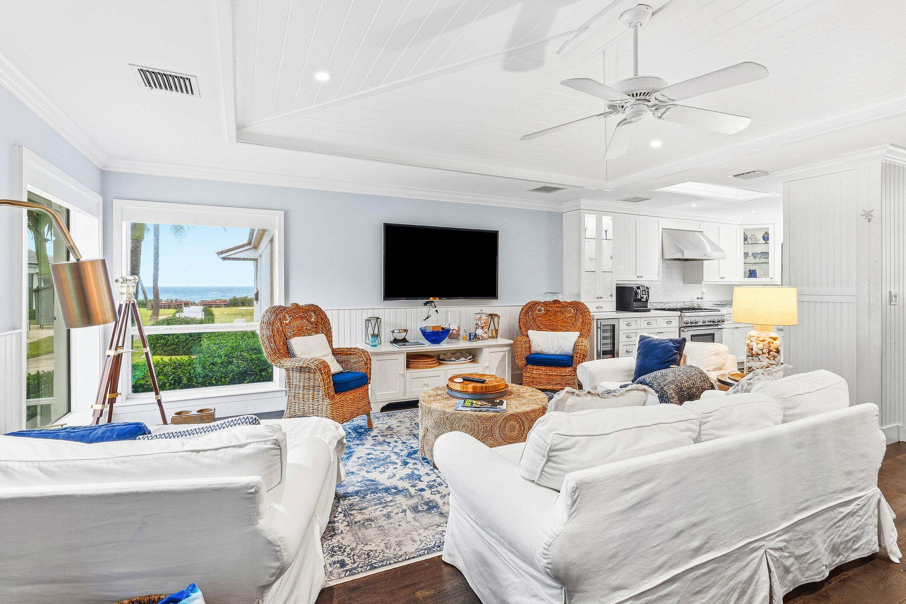 3421 South Ocean Boulevard, Unit 1 Highland Beach, FL 33487 - Photo 10 of 42 a living room with furniture a flat screen tv and a window