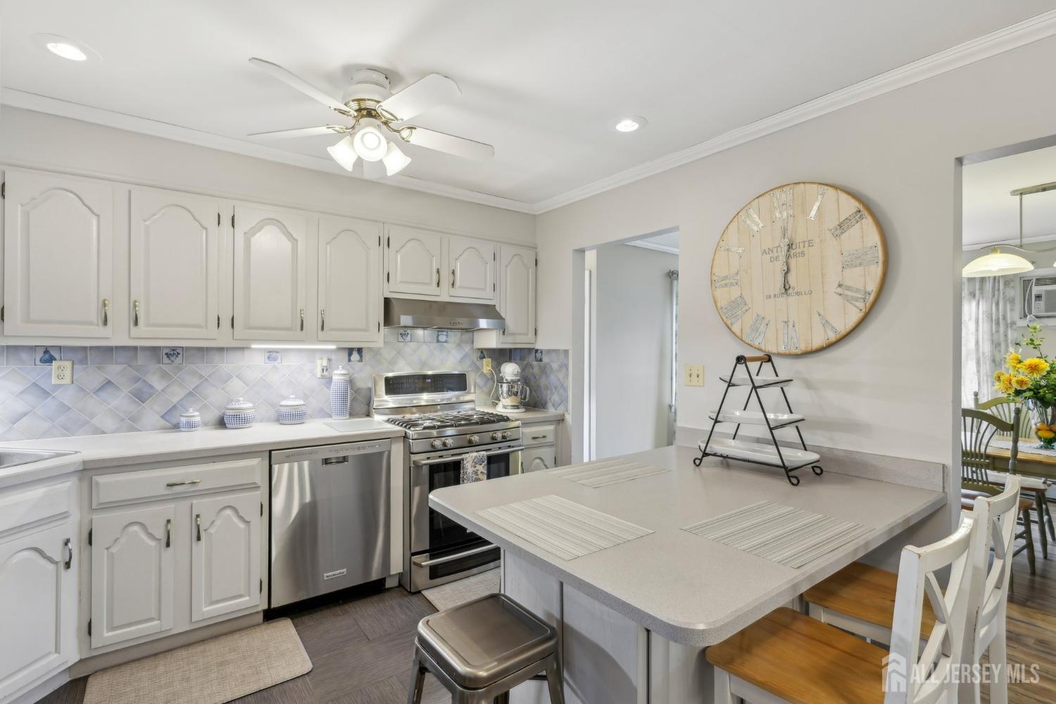 153 East Hill Road Colonia, NJ 07067 - Photo 11 of 40 a kitchen with cabinets and wooden floor